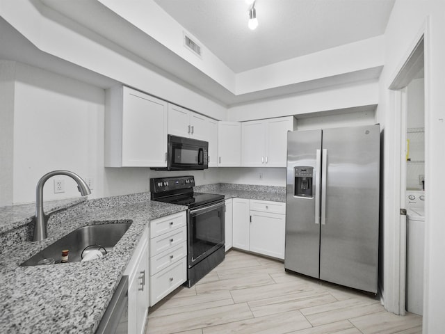 kitchen featuring light stone counters, sink, black appliances, light hardwood / wood-style flooring, and white cabinets