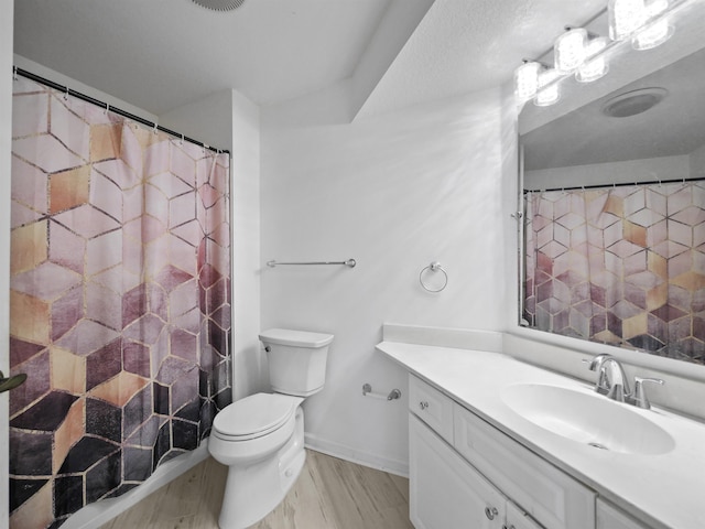 bathroom featuring curtained shower, vanity, wood-type flooring, and toilet