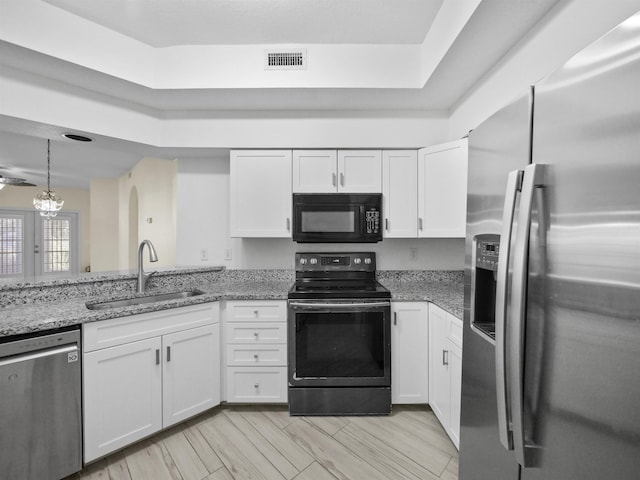 kitchen with sink, white cabinets, and black appliances