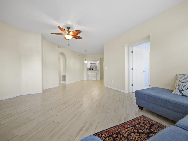 living room with ceiling fan and light hardwood / wood-style floors