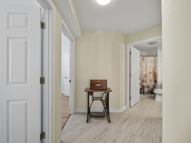 corridor with light hardwood / wood-style floors