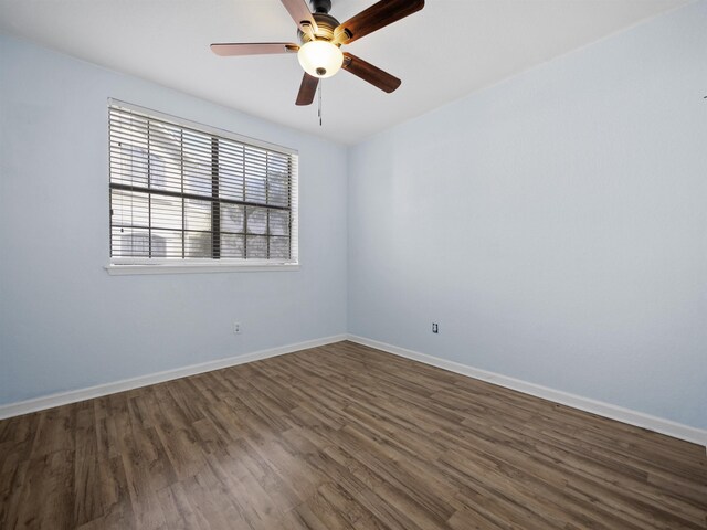 spare room with ceiling fan and dark hardwood / wood-style flooring