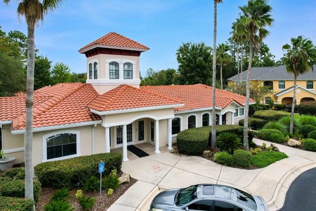 mediterranean / spanish-style home featuring french doors