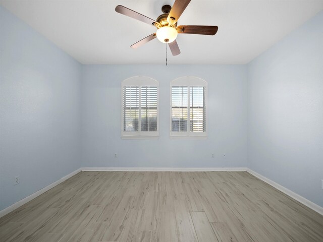 empty room with ceiling fan and light hardwood / wood-style floors