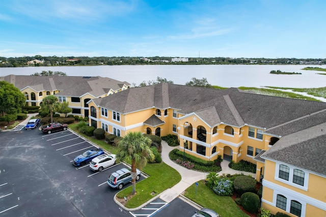 birds eye view of property with a water view