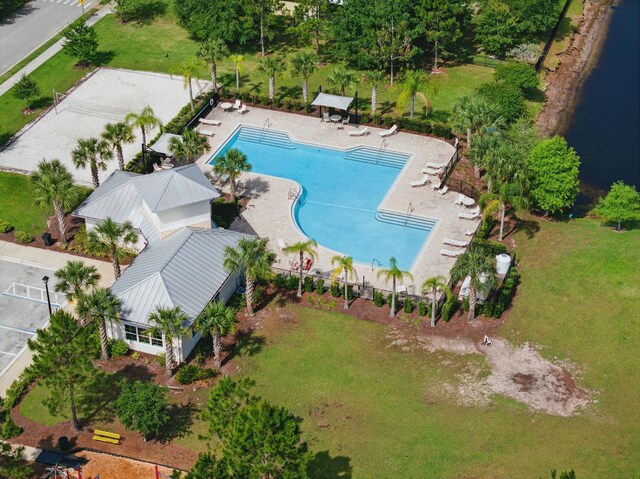 aerial view of a pool area and a large body of water