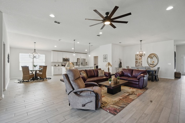 living area with a chandelier, light wood-type flooring, ceiling fan, baseboards, and recessed lighting