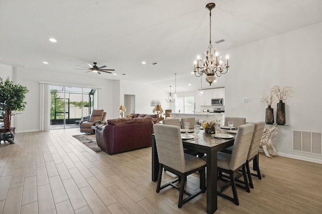dining space featuring a chandelier, plenty of natural light, light wood finished floors, recessed lighting, and ceiling fan