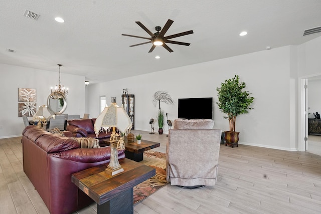 living area featuring light wood-style floors, a chandelier, ceiling fan, recessed lighting, and baseboards