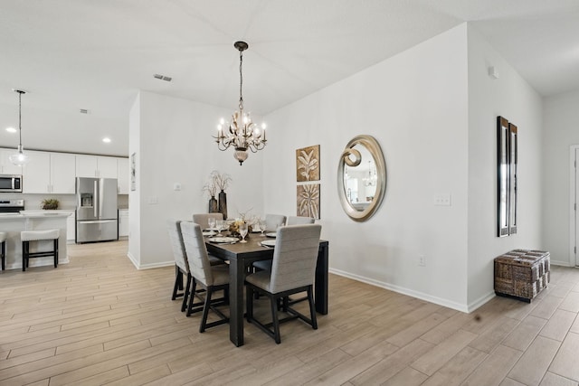dining space with light wood finished floors, baseboards, recessed lighting, and a chandelier