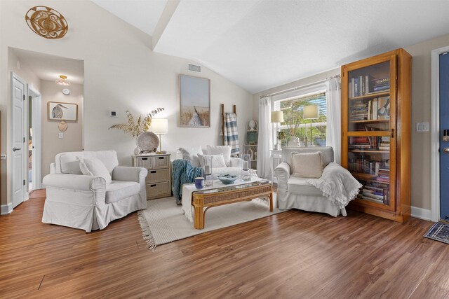 6600 Nassau St, Saint Augustine, FL 32080 - living area with lofted ceiling, wood finished floors, and baseboards