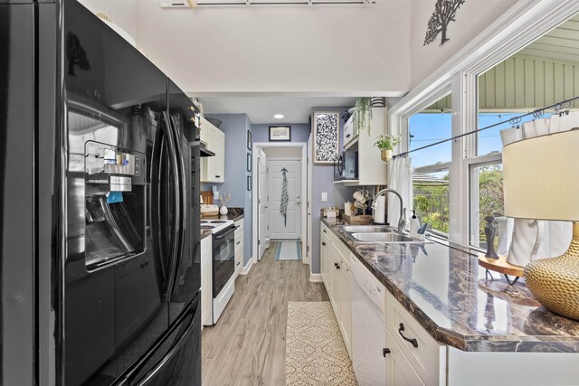 6600 Nassau St, Saint Augustine, FL 32080 - kitchen with freestanding refrigerator, a sink, range with electric stovetop, dishwasher, and white cabinetry