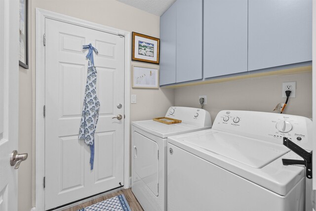 6600 Nassau St, Saint Augustine, FL 32080 - washroom featuring washer and clothes dryer, cabinet space, and light wood finished floors