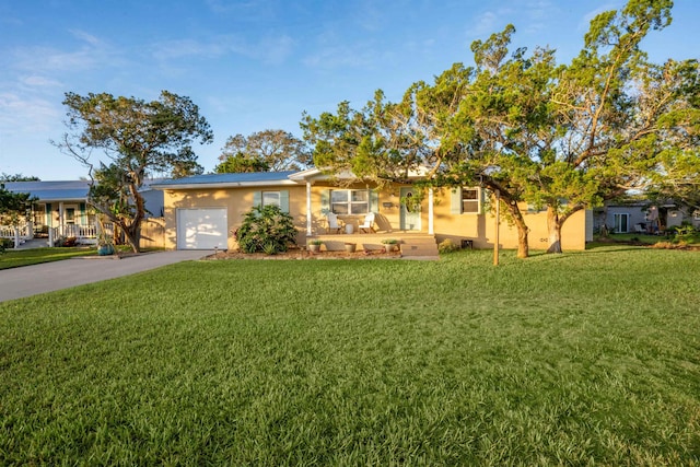 ranch-style home featuring a garage and a front lawn