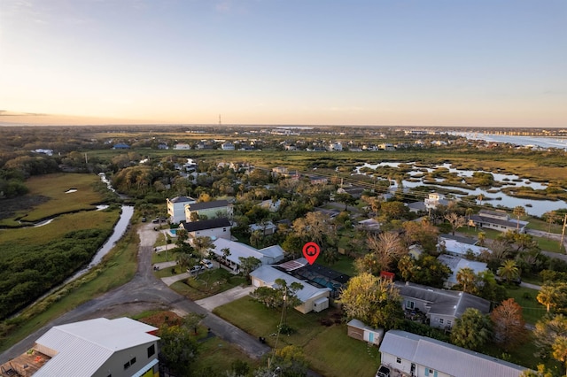 aerial view at dusk with a water view