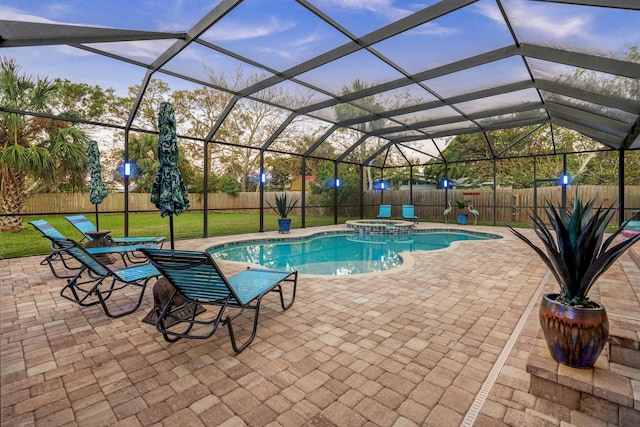 view of pool with an in ground hot tub, a yard, a patio, and a lanai