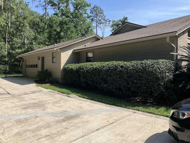 1076 Mainsail Ln, Saint Johns, FL 32259 - view of home's exterior featuring a garage, driveway, and roof with shingles