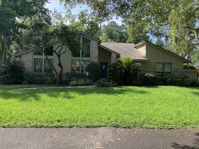 1076 Mainsail Ln, Saint Johns, FL 32259 - mid-century inspired home with a front yard and brick siding