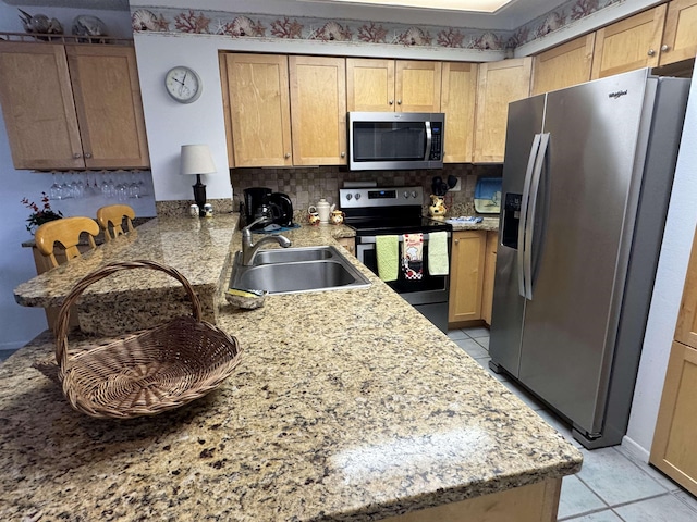 59 Village Del Lago Cir Unit 59, Saint Augustine, FL 32080 - kitchen featuring stainless steel appliances, light tile patterned floors, a peninsula, and backsplash