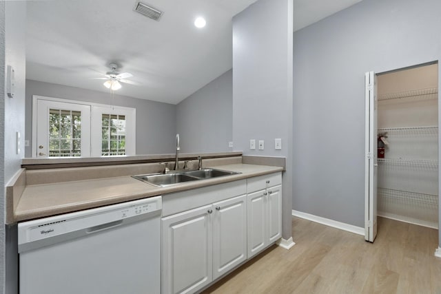 21211 Harbour Vista Cir, Saint Augustine, FL 32080 - kitchen with dishwasher, a ceiling fan, light wood finished floors, white cabinetry, and light countertops