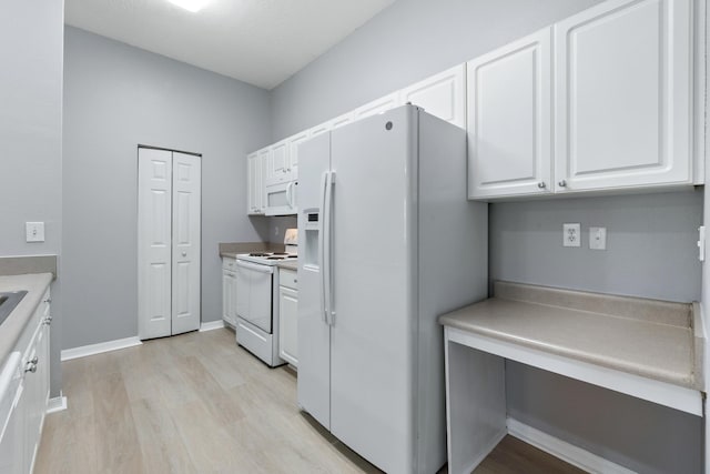 21211 Harbour Vista Cir, Saint Augustine, FL 32080 - kitchen featuring white appliances, light wood-style flooring, white cabinets, and light countertops