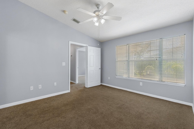 21211 Harbour Vista Cir, Saint Augustine, FL 32080 - spare room featuring lofted ceiling, dark carpet, a ceiling fan, a smoke detector, and a textured ceiling