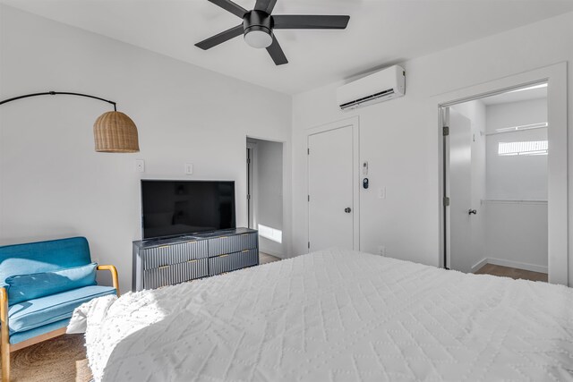 bedroom with ceiling fan and an AC wall unit