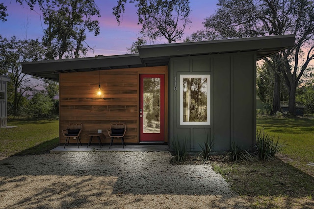 outdoor structure at dusk with a yard