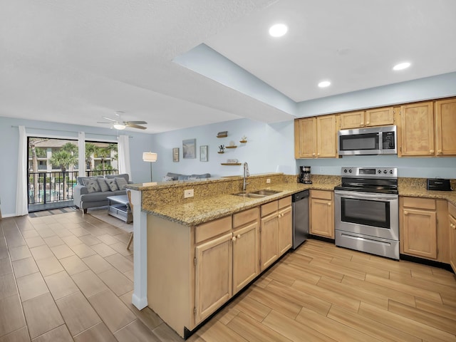 850 A1A Beach Blvd Unit 92, Saint Augustine, FL 32080 - kitchen featuring appliances with stainless steel finishes, a sink, a peninsula, open floor plan, and wood tiled floors