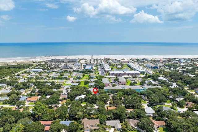 birds eye view of property featuring a water view and a beach view