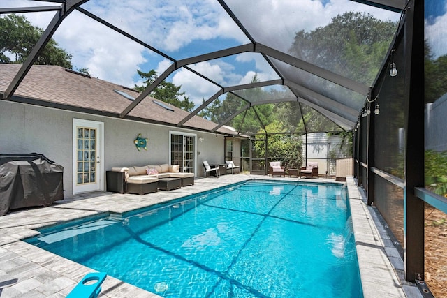 view of swimming pool with a grill, a patio, an outdoor hangout area, and glass enclosure