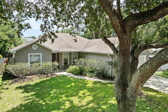 ranch-style home with a front lawn