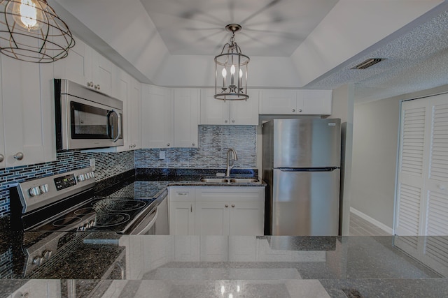 7175 A1A S A105, Saint Augustine, FL 32080 - kitchen with stainless steel appliances, a sink, backsplash, and white cabinetry