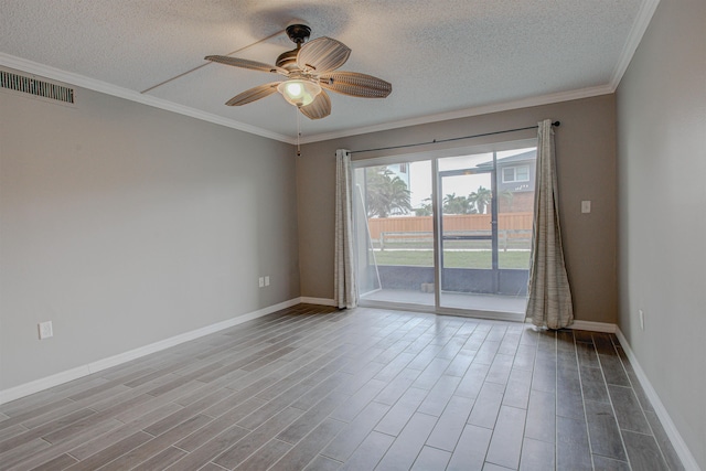 7175 A1A S A105, Saint Augustine, FL 32080 - empty room with a textured ceiling, a ceiling fan, baseboards, crown molding, and wood finished floors