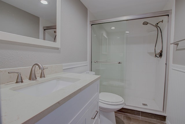 7175 A1A S A105, Saint Augustine, FL 32080 - full bath with a stall shower, vanity, toilet, recessed lighting, and wainscoting