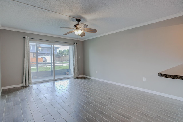 7175 A1A S A105, Saint Augustine, FL 32080 - empty room featuring ceiling fan, baseboards, a textured ceiling, ornamental molding, and wood finished floors