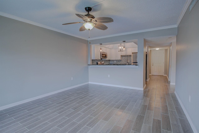 7175 A1A S A105, Saint Augustine, FL 32080 - unfurnished living room featuring a ceiling fan, baseboards, ornamental molding, light wood finished floors, and a textured ceiling