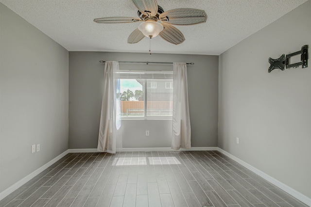 7175 A1A S A105, Saint Augustine, FL 32080 - unfurnished room with a ceiling fan, a textured ceiling, wood finished floors, and baseboards