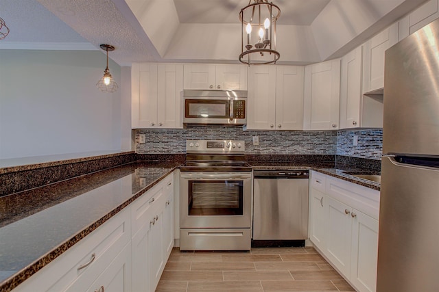 7175 A1A S A105, Saint Augustine, FL 32080 - kitchen with appliances with stainless steel finishes, white cabinetry, backsplash, and a textured ceiling