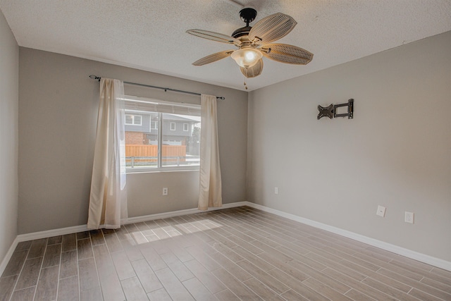 7175 A1A S A105, Saint Augustine, FL 32080 - unfurnished room with wood finished floors, a ceiling fan, a textured ceiling, and baseboards