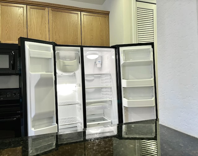 details featuring black appliances and dark stone countertops