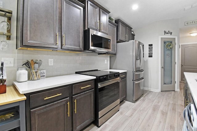 362 S Hamilton Springs Rd, Saint Augustine, FL 32084 - kitchen featuring appliances with stainless steel finishes, backsplash, light countertops, light wood finished floors, and lofted ceiling