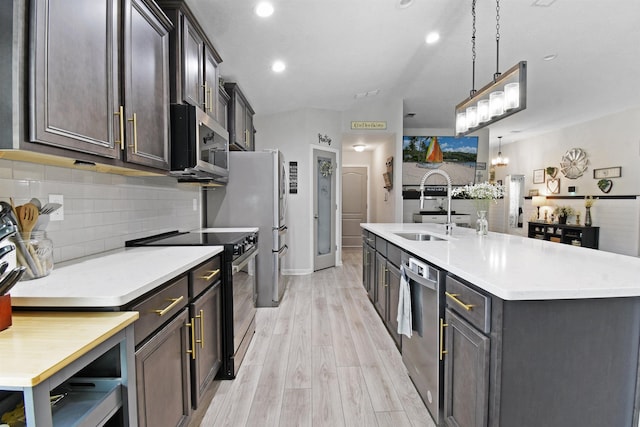362 S Hamilton Springs Rd, Saint Augustine, FL 32084 - kitchen featuring stainless steel appliances, a sink, tasteful backsplash, light countertops, and light wood-style floors