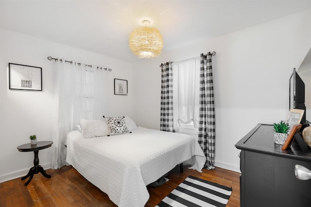 bedroom with dark hardwood / wood-style flooring