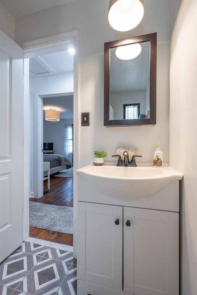 bathroom with hardwood / wood-style floors and vanity