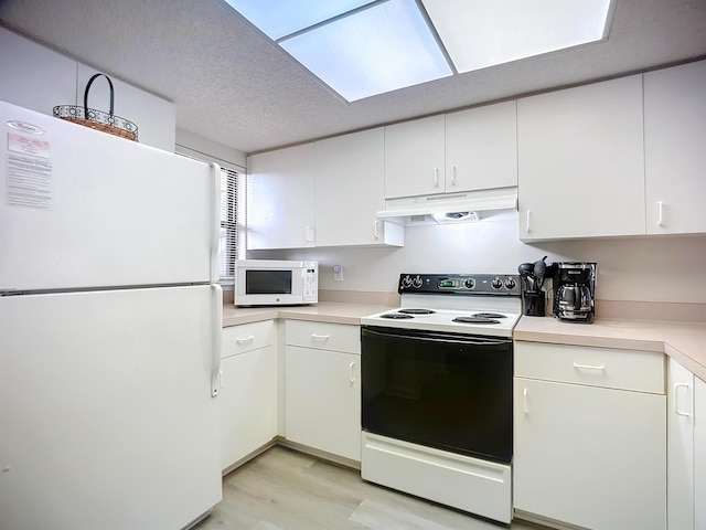 kitchen featuring white cabinets, a textured ceiling, white appliances, and light hardwood / wood-style flooring