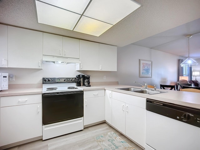 kitchen with white cabinetry, white appliances, and sink