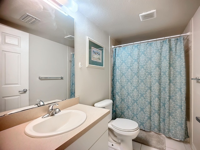 bathroom featuring toilet, a shower with curtain, vanity, and tile patterned floors