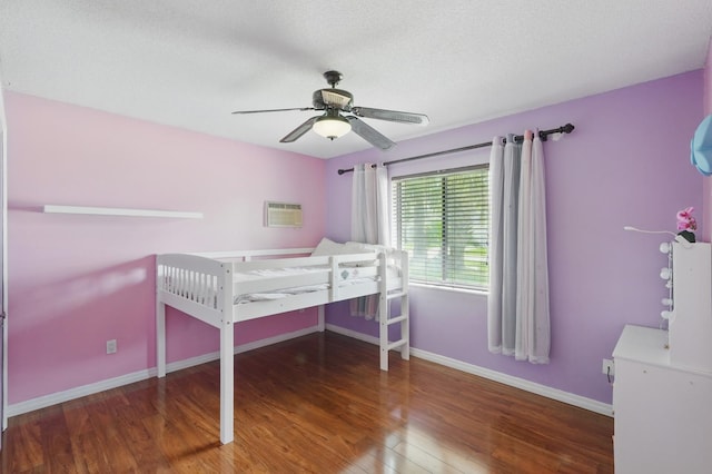 131 Boulder Rock Dr, Palm Coast, FL 32137 - bedroom featuring wood finished floors, an AC wall unit, and a ceiling fan