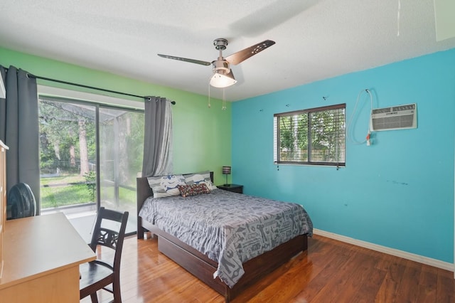 131 Boulder Rock Dr, Palm Coast, FL 32137 - bedroom featuring a wall mounted AC, wood finished floors, and a ceiling fan